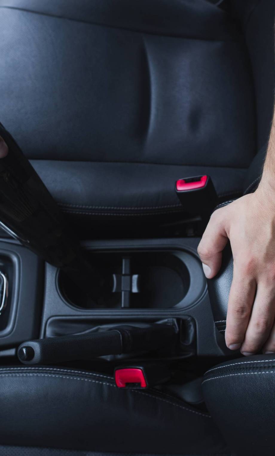 VistaCreate-310989890-stock-photo-cropped-view-car-cleaner-vacuuming-car-interior